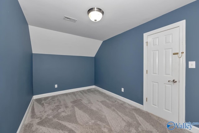 bonus room featuring light colored carpet and vaulted ceiling