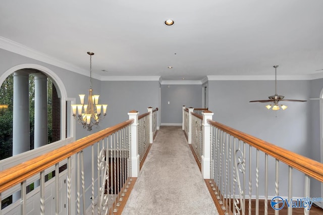 hallway with light carpet, a chandelier, and ornamental molding