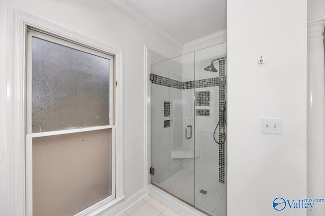 bathroom with tile patterned flooring, a shower with shower door, and ornamental molding