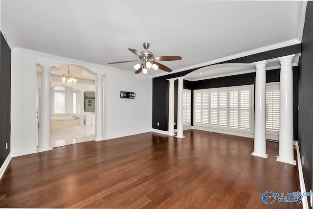 unfurnished living room featuring ceiling fan with notable chandelier, hardwood / wood-style flooring, and crown molding