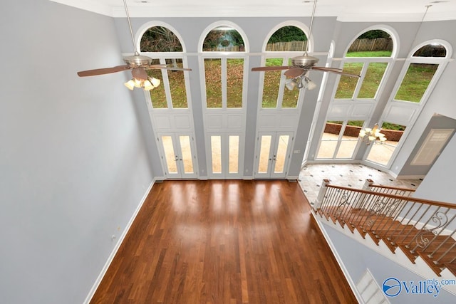 doorway featuring dark hardwood / wood-style flooring, a towering ceiling, french doors, and ornamental molding