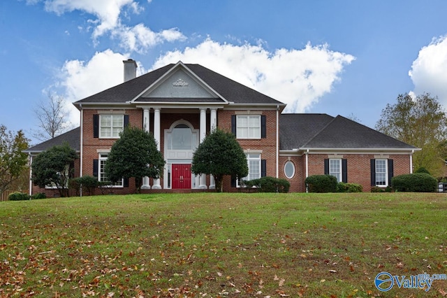 greek revival inspired property with a front lawn