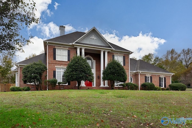 neoclassical / greek revival house with a front yard