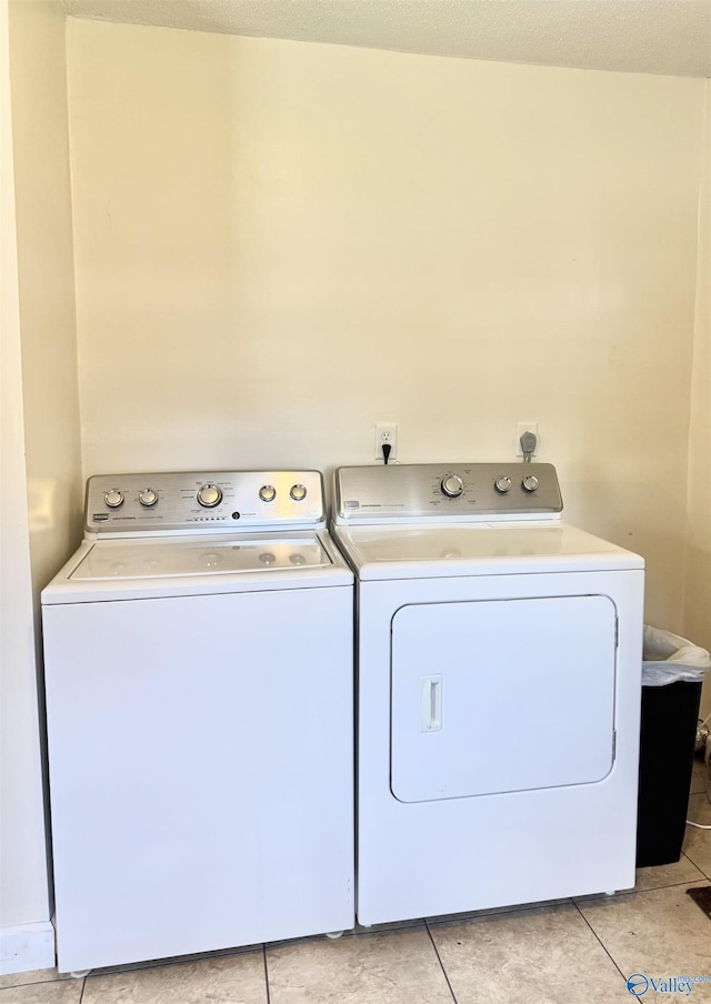 32 Kirby Rd, Hillsboro, AL 35643 - laundry room with washing machine and clothes dryer and light tile patterned floors