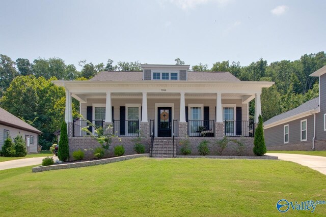 view of front of house featuring a front yard and covered porch