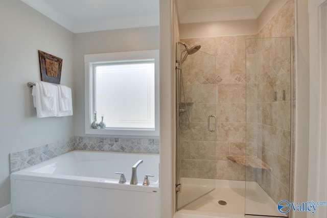 bathroom featuring a stall shower, ornamental molding, and a garden tub