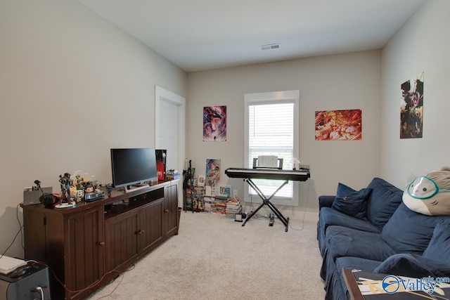 living area with light carpet and visible vents