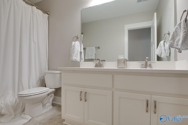 full bathroom with visible vents, a sink, toilet, and double vanity