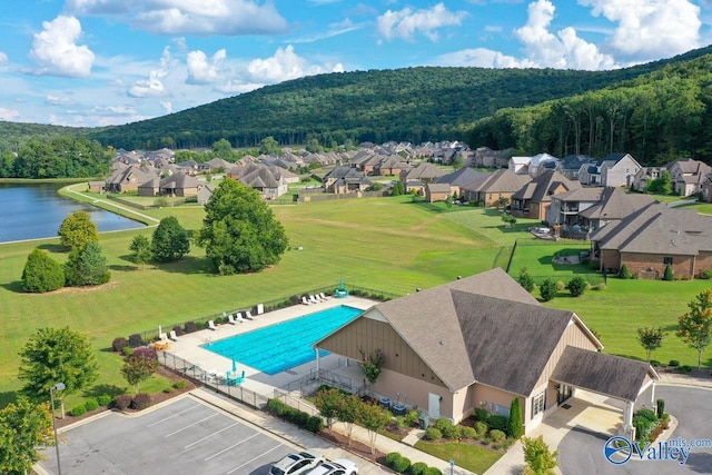 birds eye view of property with a water view and a residential view