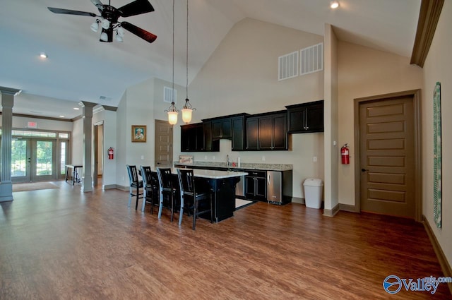 kitchen featuring dark wood-style flooring, decorative columns, light countertops, visible vents, and open floor plan