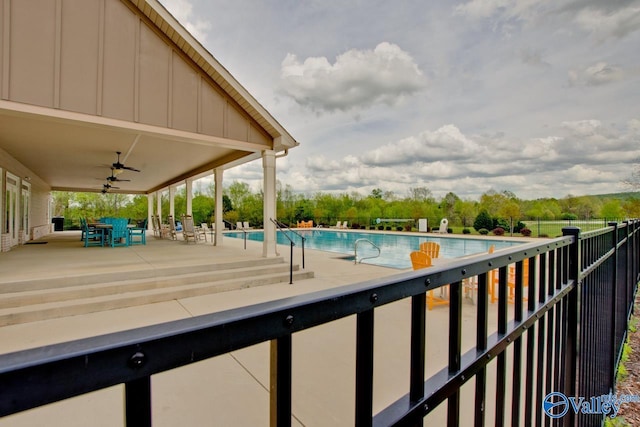 community pool with a patio area, ceiling fan, and fence