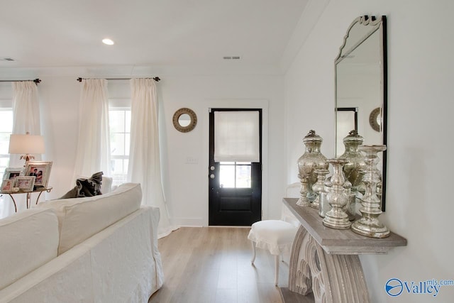 entryway with light wood-type flooring, visible vents, and recessed lighting