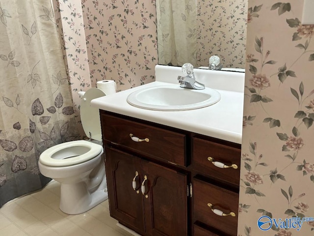 bathroom featuring vanity, toilet, and tile patterned floors