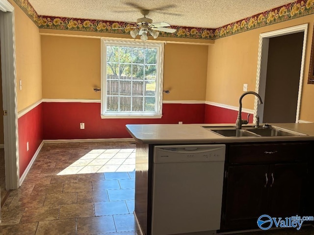 kitchen with sink, dishwasher, a textured ceiling, and ceiling fan