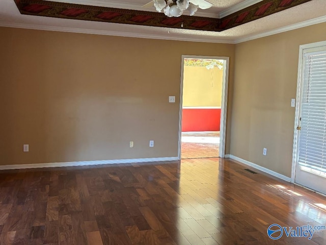 empty room with ornamental molding, ceiling fan, and dark hardwood / wood-style flooring