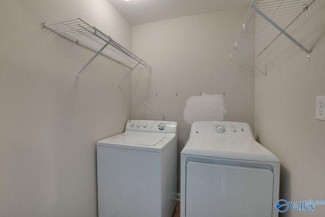 clothes washing area with washing machine and clothes dryer