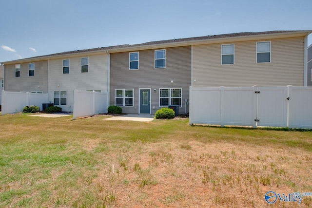 rear view of house with a yard