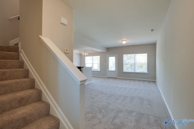 staircase with light colored carpet