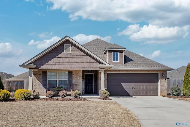 view of front of property featuring driveway, fence, a shingled roof, a garage, and brick siding