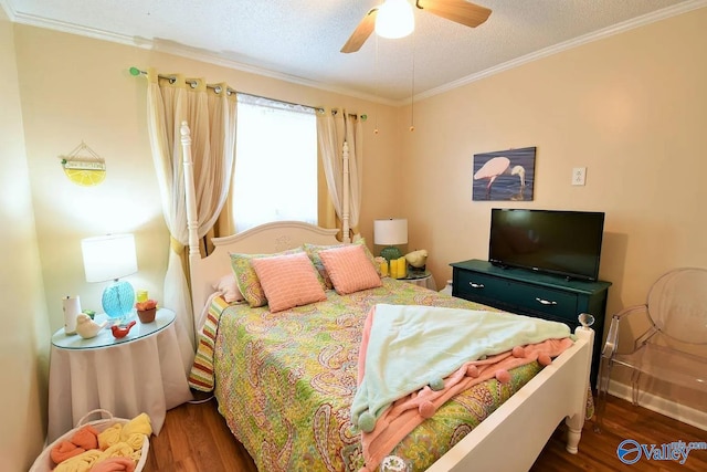 bedroom with crown molding, dark wood-type flooring, ceiling fan, and a textured ceiling