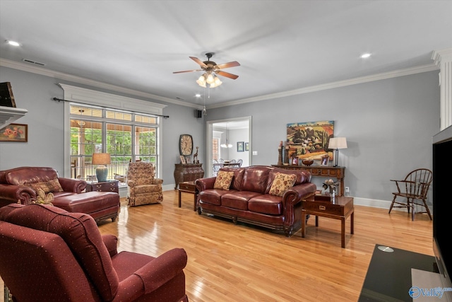 living room with baseboards, ceiling fan, light wood-style flooring, and crown molding