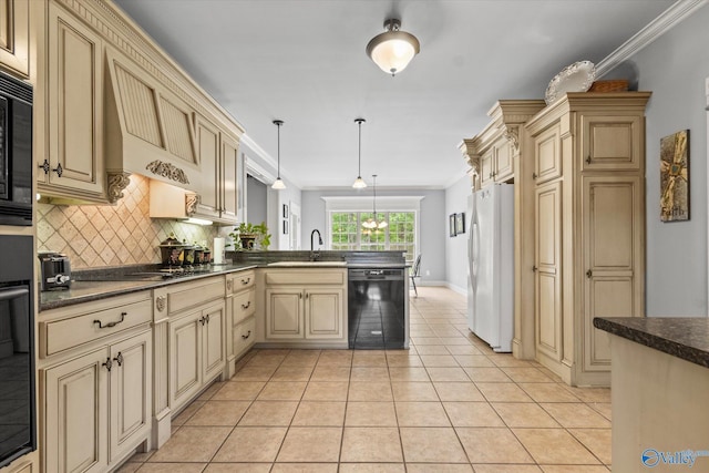 kitchen with black appliances, cream cabinetry, and a peninsula