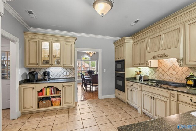 kitchen with crown molding, black appliances, light hardwood / wood-style flooring, and tasteful backsplash