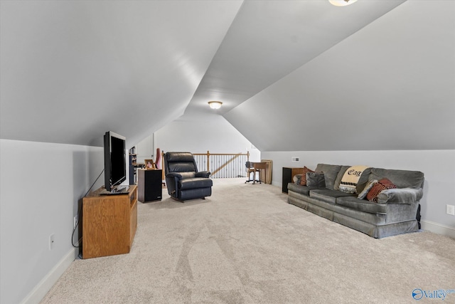 interior space featuring baseboards, carpet floors, an upstairs landing, and vaulted ceiling