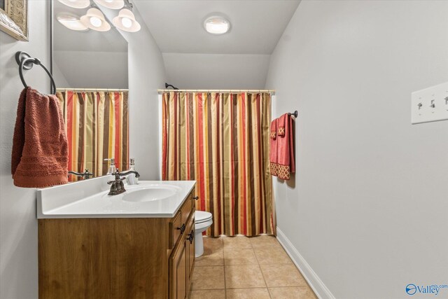 bathroom featuring tile patterned flooring, toilet, and vanity