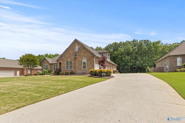 traditional-style home featuring brick siding, concrete driveway, and a front yard