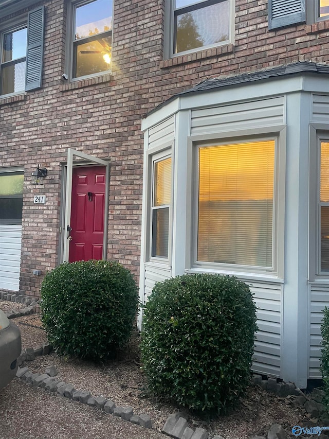 doorway to property with brick siding