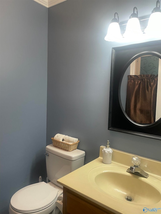 half bathroom with vanity and toilet