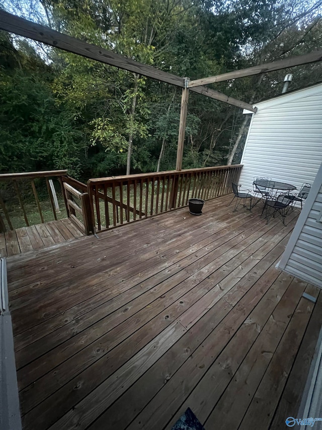 wooden deck featuring outdoor dining area