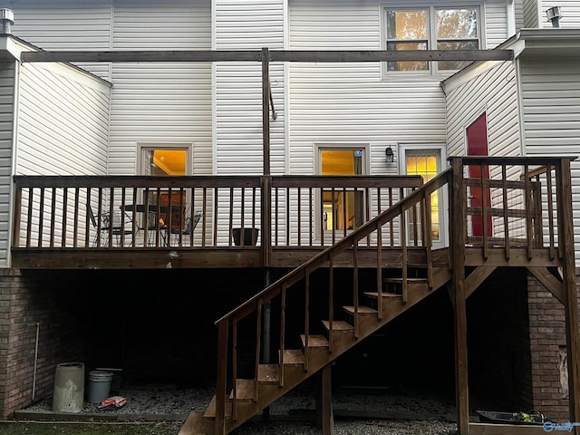 rear view of house with stairway and a wooden deck