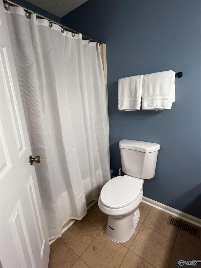 full bathroom with tile patterned flooring, baseboards, visible vents, and toilet