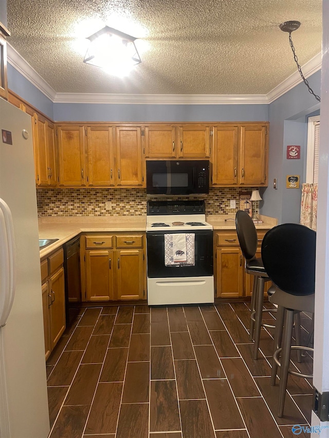 kitchen with black appliances, light countertops, and crown molding