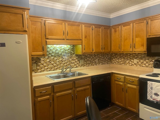 kitchen featuring tasteful backsplash, brown cabinets, light countertops, black appliances, and a sink