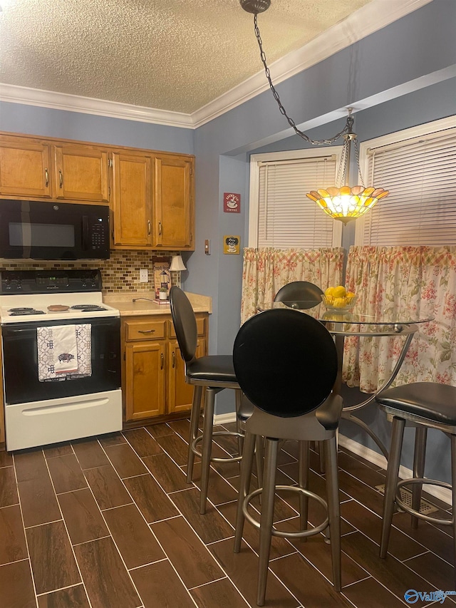 kitchen with light countertops, electric range, ornamental molding, wood tiled floor, and black microwave