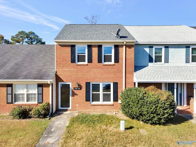 1829 Brownstone Ave SW, Decatur, AL 35603 - townhome / multi-family property with brick siding, roof with shingles, and a front lawn