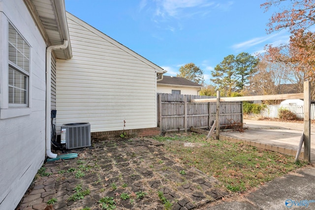 view of yard with central air condition unit and a patio area