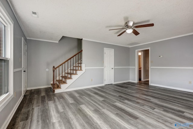 interior space with ceiling fan, a textured ceiling, hardwood / wood-style flooring, and ornamental molding