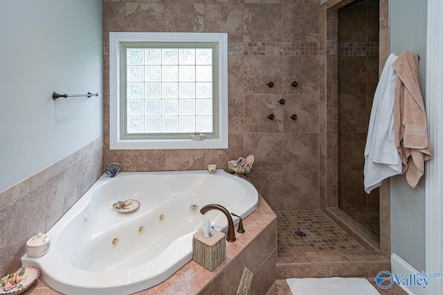 bathroom featuring tile walls and plus walk in shower