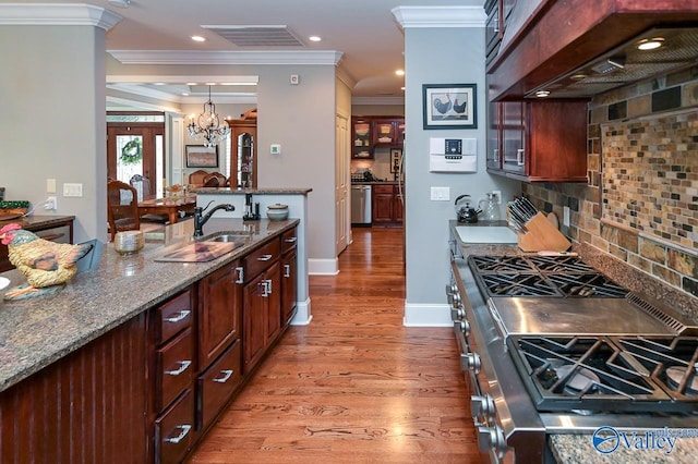 kitchen featuring custom exhaust hood, stone countertops, hardwood / wood-style flooring, stainless steel appliances, and decorative backsplash