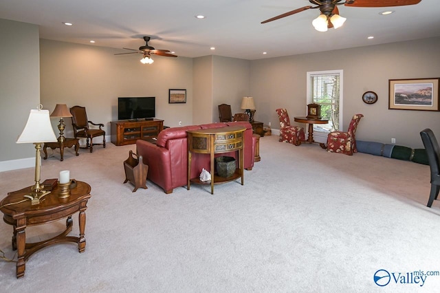 carpeted living room with ceiling fan