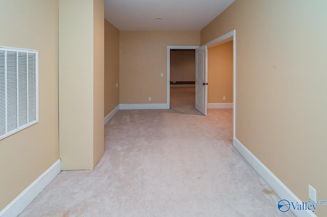 corridor featuring light colored carpet