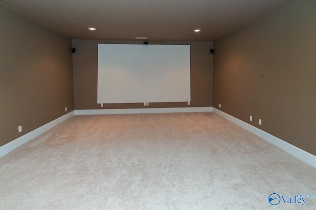 home theater room featuring light colored carpet