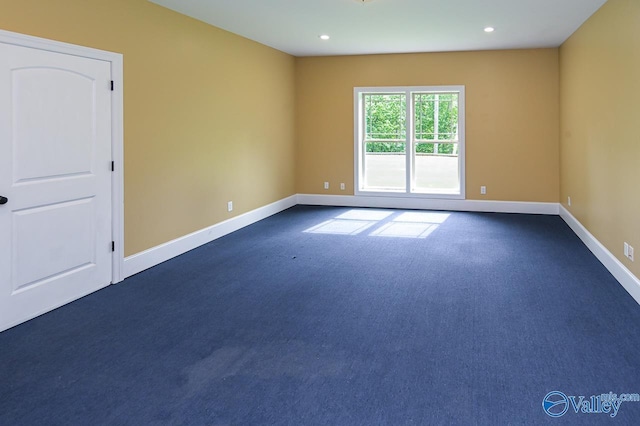 empty room with dark carpet