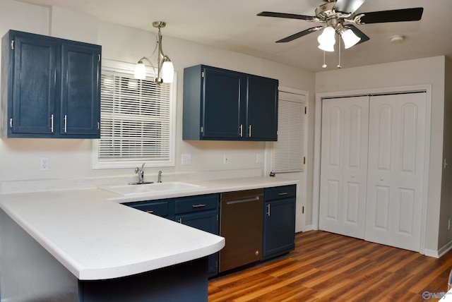 kitchen with hanging light fixtures, stainless steel dishwasher, sink, dark wood-type flooring, and blue cabinets