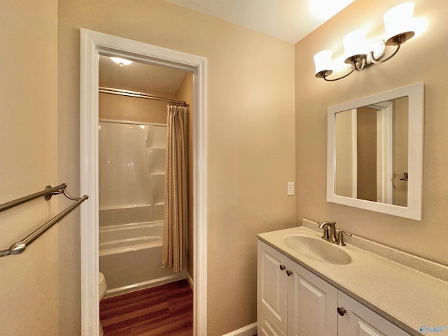 bathroom with toilet, hardwood / wood-style flooring, a shower with curtain, and vanity