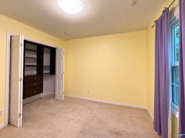 unfurnished bedroom featuring light carpet